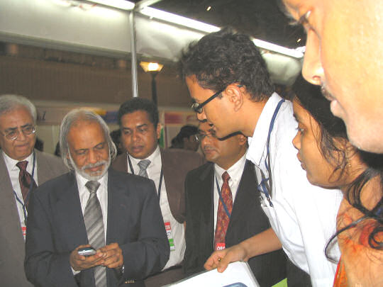 The Honorable Science and ICT Minister Dr. Moyeen Khan experiencing 3SM Bangla Text SMS at our stall.