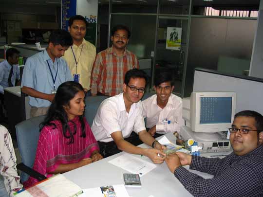 The 3SM representative handing over the final version of the Bangla SMS software to the Citycell AVP.